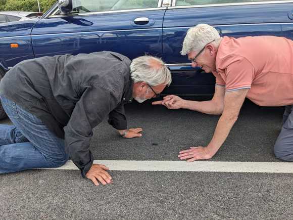 
Very dodgy photo of us confirming that the small puddle under the car is, indeed, brake fluid. 