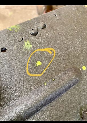 The dripped paint for locating hole for tranny mount 