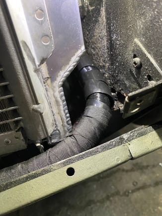 There is small flange with a hole that captures the AC condenser that had to be ground down on each side to reduce chance of rub through on oil lines. (This is driver, passenger side below has same issue). 
