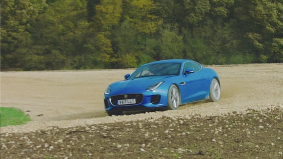 Frame from The Grand Tour with one of the guests driving it around their new track