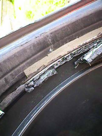 Close up of the hard, breaking plastic tube looking onto the SS clamp.