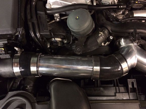 The two 45 degree silicone couplers have about 1.5" of the ends cut off to clean up excess material and show off the polished pipes.