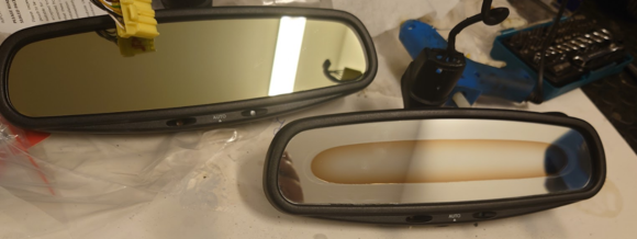 Managed to find 'new' rear view mirror from breaker w/correct yellow plug. Old mirror fluid did not leak but it is disappearing slowly as seen on photo. 