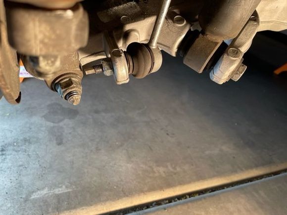 Bottom of lower control arm with shock absorber and sway bar link attached