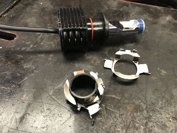 Metal Adaptor fitted over plastic LED barrel socket for fitting into the high beam housing.