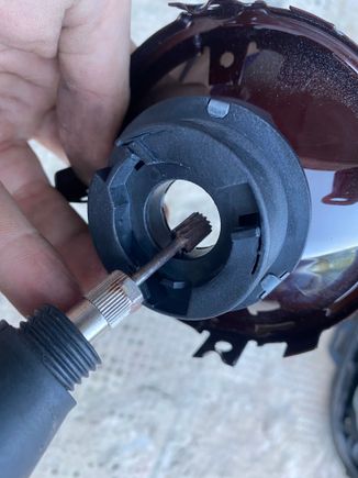 Use a Dremel with a carbide bur to increase the diameter of the reflector's bulb holder hole. DO NOT grind the reflector part of the bulb holder hole. 