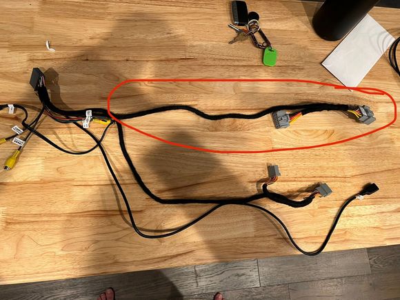 The wiring harness with part that's too short circled in red.