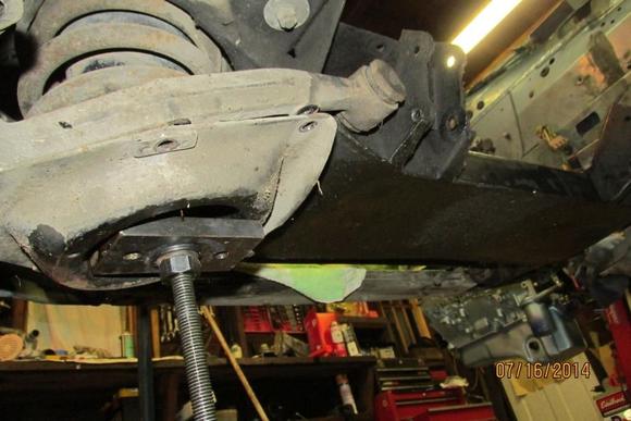Bottom side: a 1/2" thick flatbar drilled large enough to allow the rod freedom-you don't want it to bind.  The bar acts to level the load. Very valuable when reinstalling.