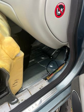 Black flashlight sitting on floorpan