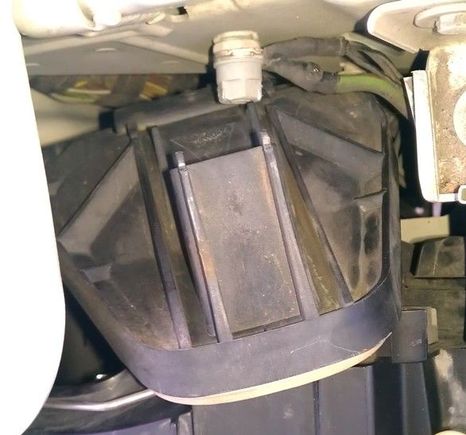 Rotate cover towards radiator and wiggle out of cramped area.  :(