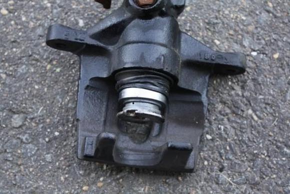 Starting to remove the piston.  Rotate till the piston will not come out any more.  Then pull the piston straight out.  If you are even at a slight angle, it will fight you the whole way.  You see that the boot will stretch to fit over the piston.