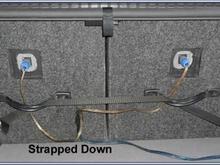 Back of speakers have handles screwed with T-nuts and strapped down to hooks in car. Removable plugs.