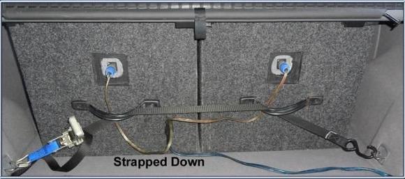 Back of speakers have handles screwed with T-nuts and strapped down to hooks in car. Removable plugs.