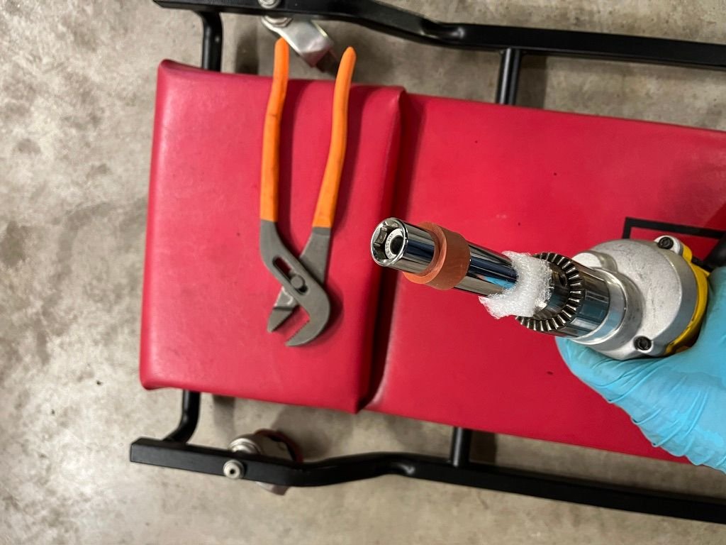 Assembled fixture for centering pilot hole. Adjustable wrench for grabbing on to Silicone sleeve to keep the socket from spinning.