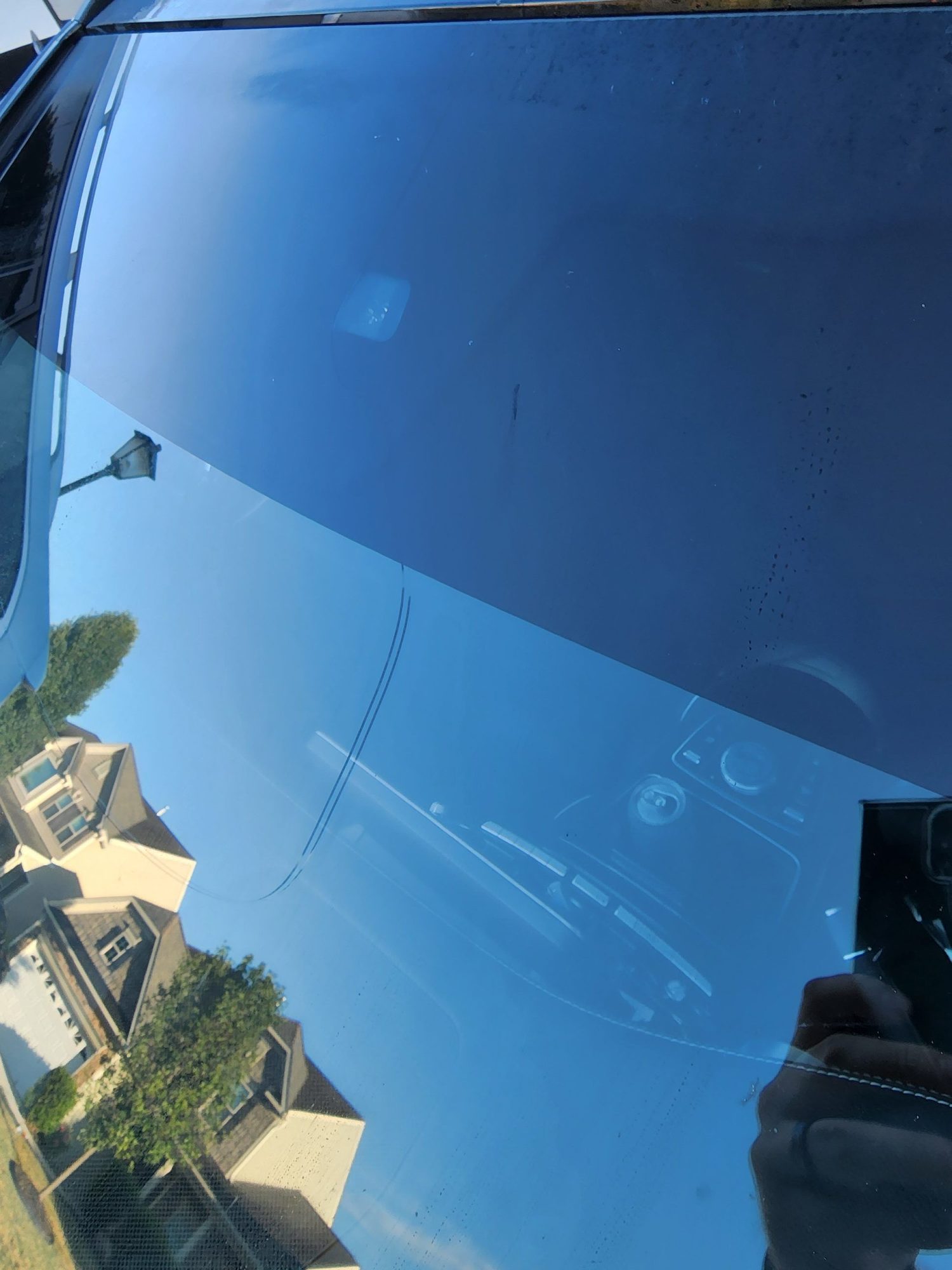 Cracked glass roof panel between windshield and sunroof