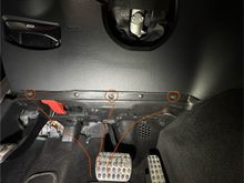 Remove the 3 T15 to lower the plastic panel under the dash; makes is possible to reach up and under to maneuver the battery and tray.