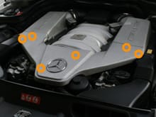 There are six clips underneath (location shown in orange circles) you need to release in order to get this portion of the engine cover off.