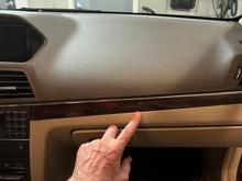 Fingertip points to the crack on passenger side dash trim