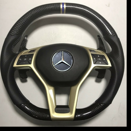 Carbon Fiber gloss finish with double yellow and white chapter ring 'tri ring'
Perforated leather with yellow and white cross stitching.
Gold central  trim piece option
Airbag cover in in alcantara trim option