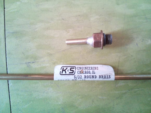 5/32" brass tubing from the hobby store, this is the same diameter of the plastic tubing.  I cut a short length and silver soldered it to original fitting.  I removed the o-ring round the threads first.