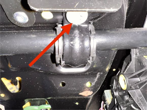 One of the screws. Remove it and it will kisses the c clamp that holds the seat bottom to the frame. 