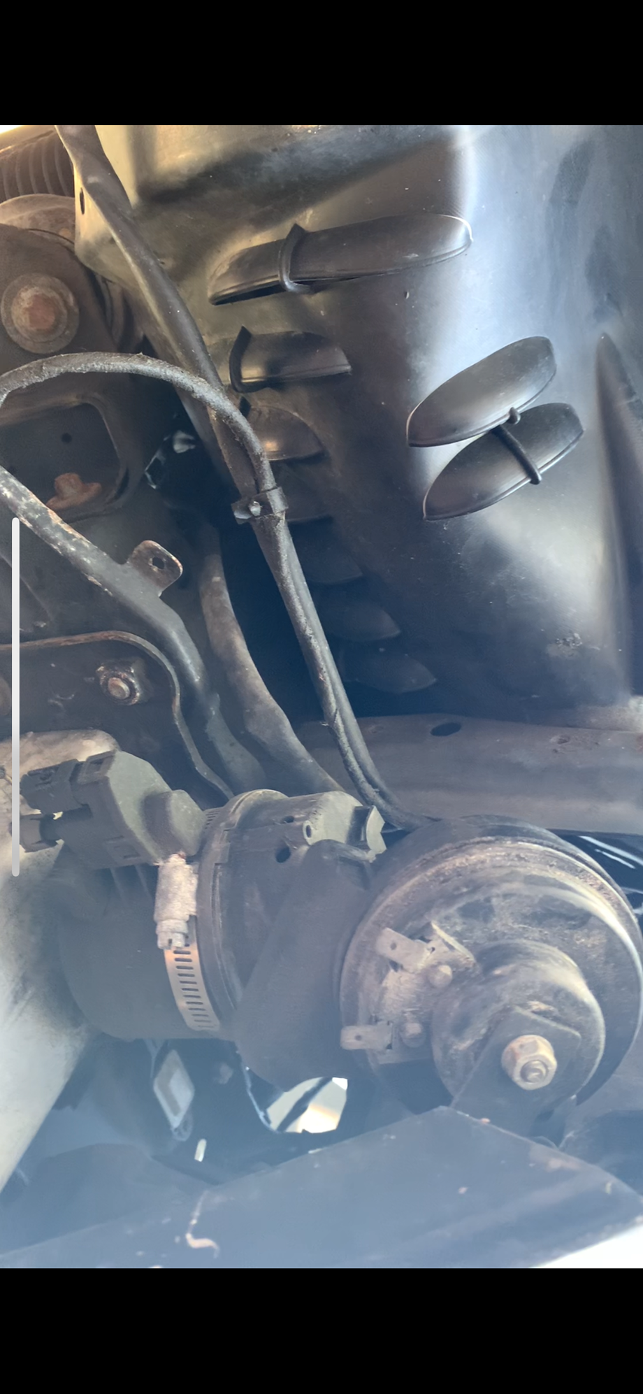 These pre-wreck pics show it mounted between impact absorber and behind the horn.  