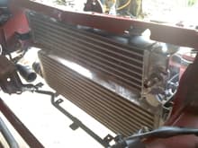 018
an e-bay rx7 oil cooler.  Will need to source out a couple of 16mm x 1.5 straight thread -8 90 degree adapters to make this work.  Still I may have to tip the radiator back some; or merely run the lines out the front side.  Still a work in progress.