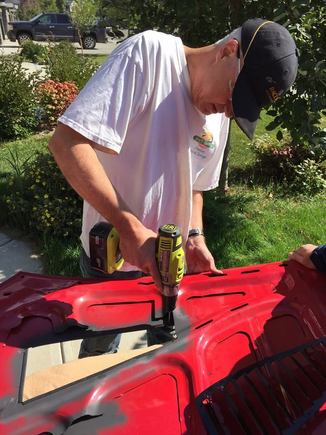 After adding the rubber trim, the louvers are held in place and a center punch marks the spots.  Drilling ensues.