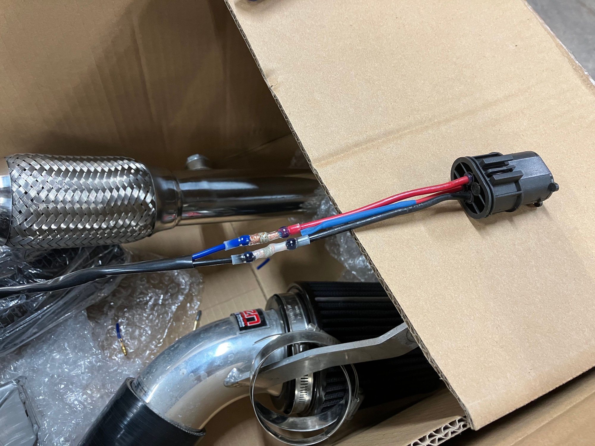 Just like this. On the MINI side there are 3 wires. You�ll only need two of these so I�ve just snipped off the 3rd wire and heat shrinked it to seal it from the elements. Keep the Red and Black wires on the plug side. These will need to be connected to the blue and black wires on the fan. Red to Blue. Black to Black. Simple enough. I used the same crimpless butt connectors I used for the ecu wiring here as well.