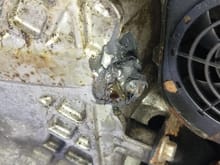 The oil pan bolt had been badly repaired and was leaking a lot