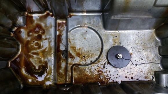 Dragging a high power magnet around after dropping the oil pan.
Happy to discover - No metal particulates. The crap in the pan are remnants of a disintegrated rubber drain plug O-ring and bits of various crud that had fallen in when dropping the pan.