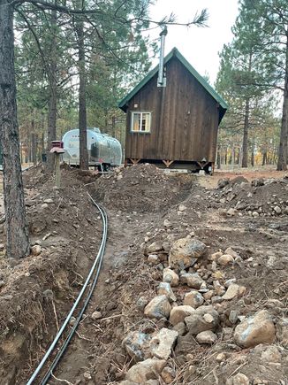 while I have the excavators we dug many extra trenches for more yard hydrants and most exciting, bringing water and fiber optic to the cabin that is 630 ft away; I also prep it for a add on bath with running toilet and shower