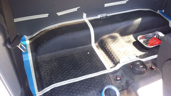 Started by removing the passenger seat to get easier access to the back area and then tapes off the actual floor space the box is going to cover
