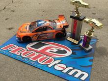 My Xray and its Invitational trophies!  I'm running an ORCA TX 17.5, Orion R10 Pro US Stock Spec ESC, Savox 1252 low-profile servo, Reedy 5500 60C lipo, Protoform Mazda Speed6 body, and Contact RC foam tires.  Controlled by a KO Propo EX1-KIY