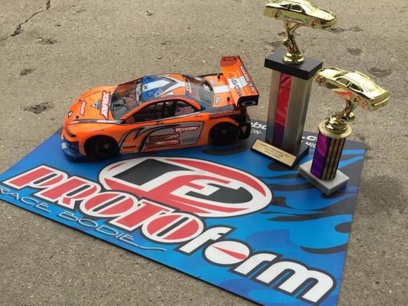 My Xray and its Invitational trophies!  I'm running an ORCA TX 17.5, Orion R10 Pro US Stock Spec ESC, Savox 1252 low-profile servo, Reedy 5500 60C lipo, Protoform Mazda Speed6 body, and Contact RC foam tires.  Controlled by a KO Propo EX1-KIY