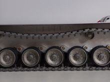 Side view - all metal road wheels, idler, sprockets, and return rollers.  They seem to have bearings installed.