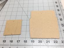 Here we have cardboard patterns for both the battery floor and the hatch cover. Note the subtle curves and notches in the floor necessary for a good fit.