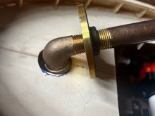 And it fits!  I had to use a 1/2" NPT tap on the bottom side of the flange to open the threads up for the elbow.