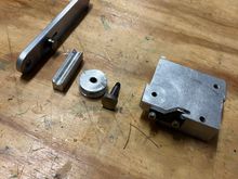 Here are all the pieces. The handle with the adjustable shoe follower attached, the shoe, the wheel, the axle, the block and screwed into the block is the STEEL stop.  Don't even think of making the stop out of aluminum - it will fail.