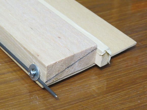 9/16" high hardwood leading front edge has a strip of masking tape the full length. 