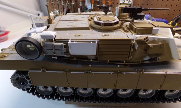 Fabricated my own exhaust deflector.  Simulated padlocks and replacement storage bin handles added.  Handles added to the CIPs (Combat Identification Panels).  Still need to make tie down straps for the CIPs and the ammo box tray. 