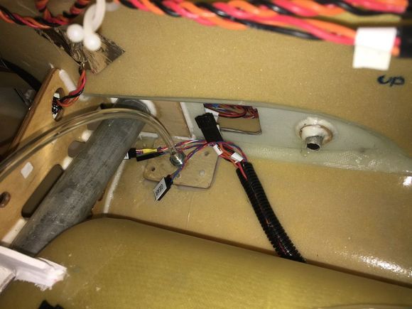 Wing connection in plastic loom to protect wires from intake air.