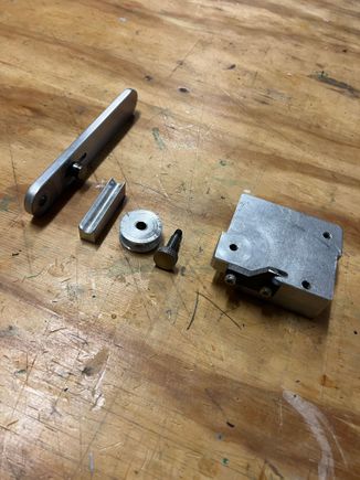 Here are all the pieces. The handle with the adjustable shoe follower attached, the shoe, the wheel, the axle, the block and screwed into the block is the STEEL stop.  Don't even think of making the stop out of aluminum - it will fail.