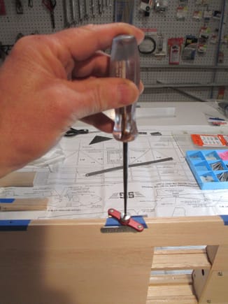 I like to use the hinge drill jig made by Robart.  I find that using an awl to locate the indentation that I had previously made is the best way to locate the jig in the exact position.
