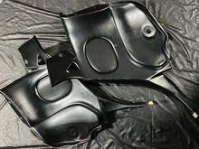 Two RHD panels with belt pass through/strut base cover present but snapped in half.