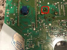 The red box shows what looks like burn marks around the solder joint. This is 1 of 4 solder joints to the speedometer face. It must be de-soldered then soldered in place when necessary.