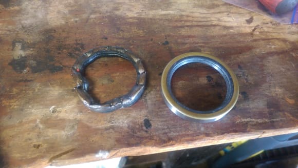 Old rear wheel seal after being removed, versus the new one.