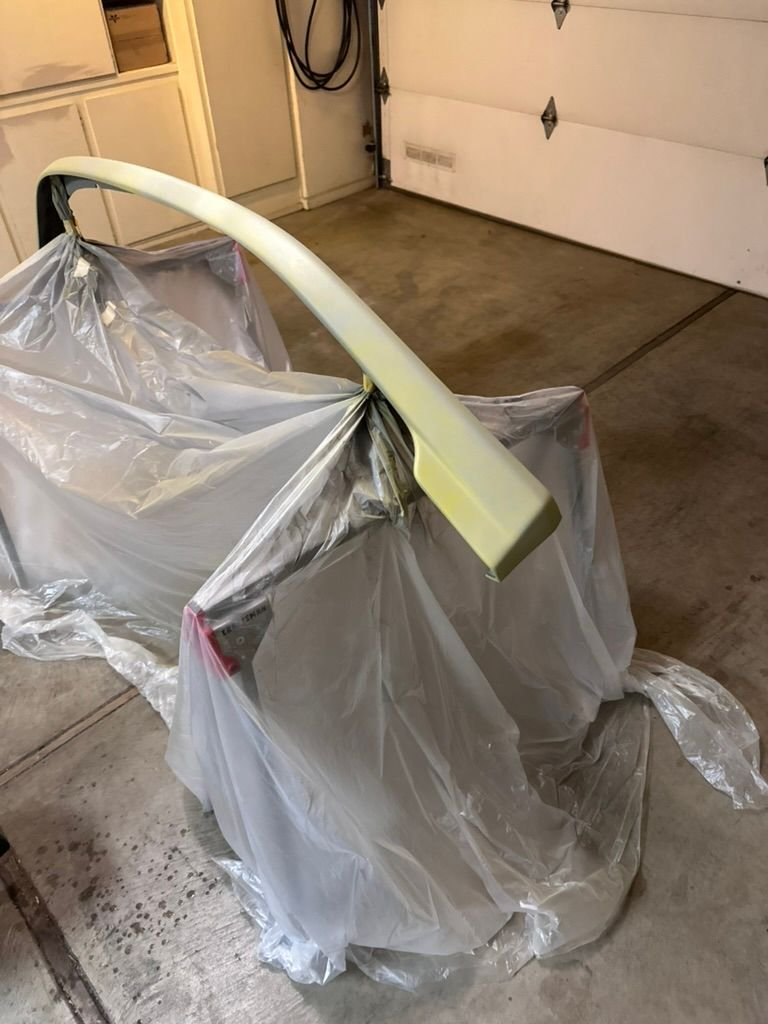 After sanding the whole surface and using Sprayway glass cleaner and a tack cloth, I used adhesion promoter and a can of primer. 