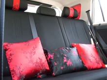 Throw pillows done in sakura print with matching headrests for front and rear seats. C-pillar cubbies are also dressed with this fabric.