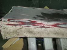 Driver rear quarter ground effect. Looks to be red/maroon under the white.